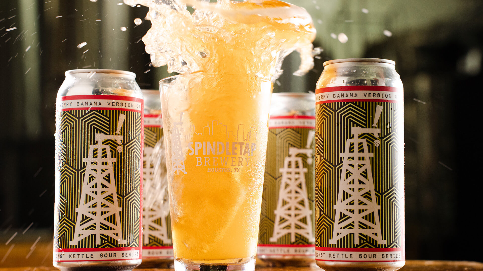 A glass of beer being splashed inside a brewery in a Houston corporate event venue.