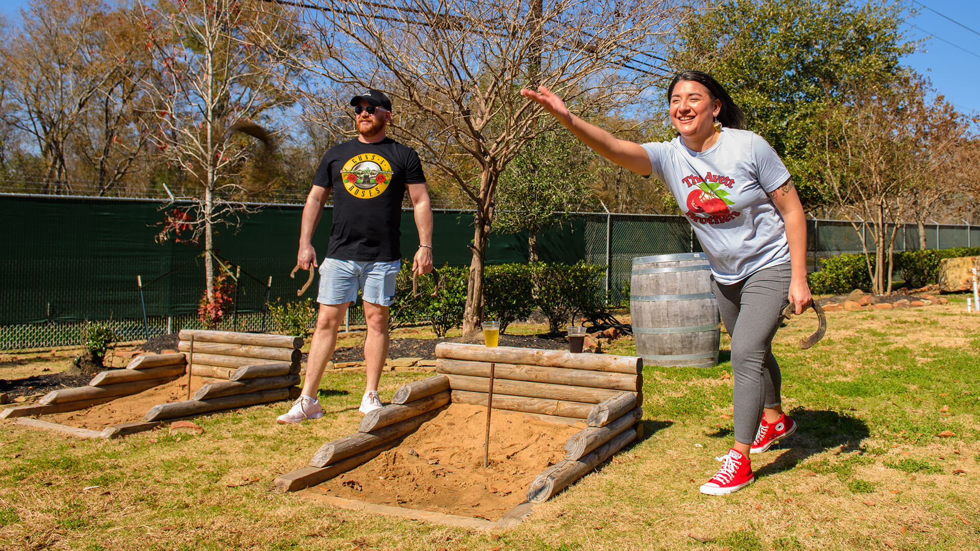 2 employees enjoying a company party with a game of horshoe at a houston corporate event venue