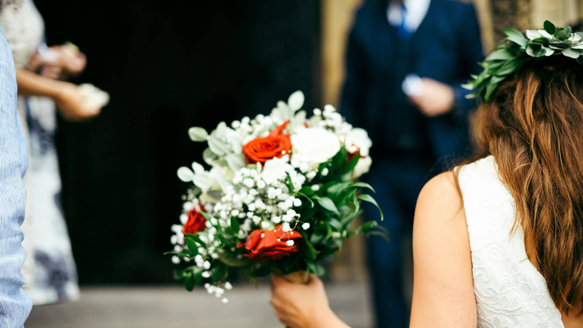 A bride walking down the isle with white roses at a Wedding Venue